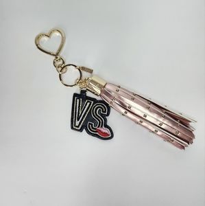 New without tags. Victoria's Secret Keychain. Rose gold leather studded tassel.